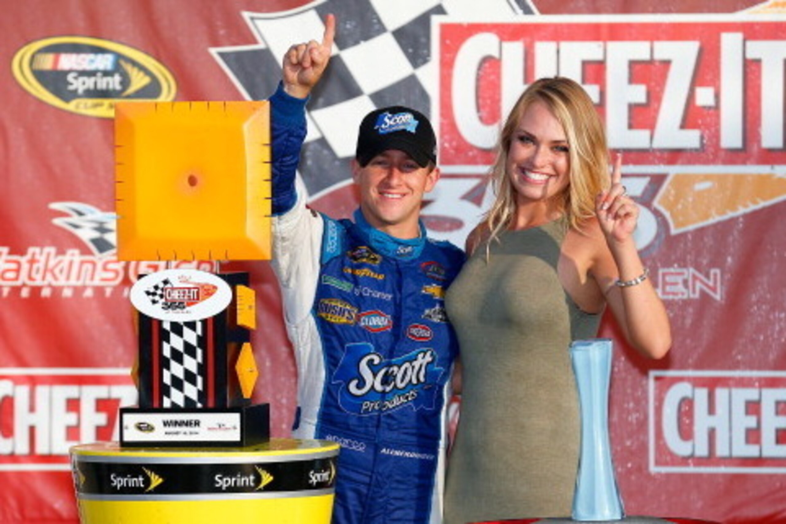 WATKINS GLEN, NY - AUGUST 10:  AJ Allmendinger, driver of the #47 Scott Products Chevrolet, poses with girlfriend Tara Lea in Victory Lane after winning the NASCAR Sprint Cup Series Cheez-It 355 at Watkins Glen International on August 10, 2014 in Watkins 