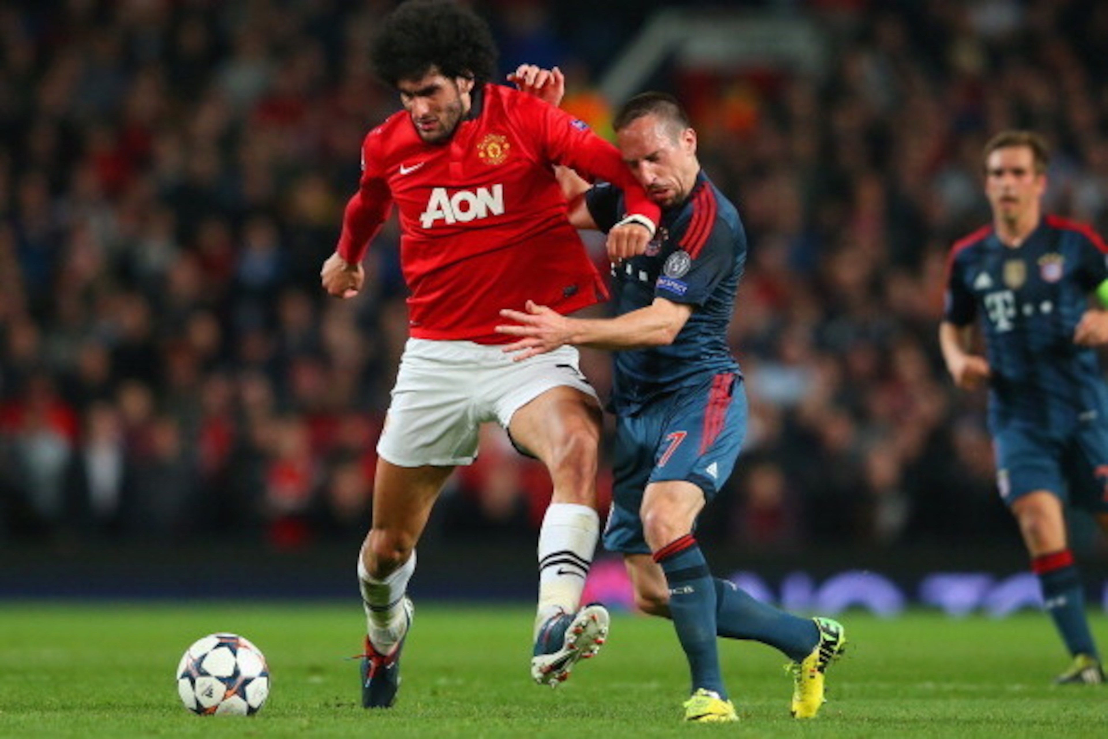 MANCHESTER, ENGLAND - APRIL 01: Marouane Fellaini of Manchester United and Franck Ribery of Bayern Muenchen battle for the ball during the UEFA Champions League Quarter Final first leg match between Manchester United and FC Bayern Muenchen at Old Traffor MANCHESTER, ENGLAND - APRIL 01: Marouane Fellaini of Manchester United and Franck Ribery of Bayern Muenchen battle for the ball during the UEFA Champions League Quarter Final first leg match between Manchester United and FC Bayern Muenchen at Old Traffor