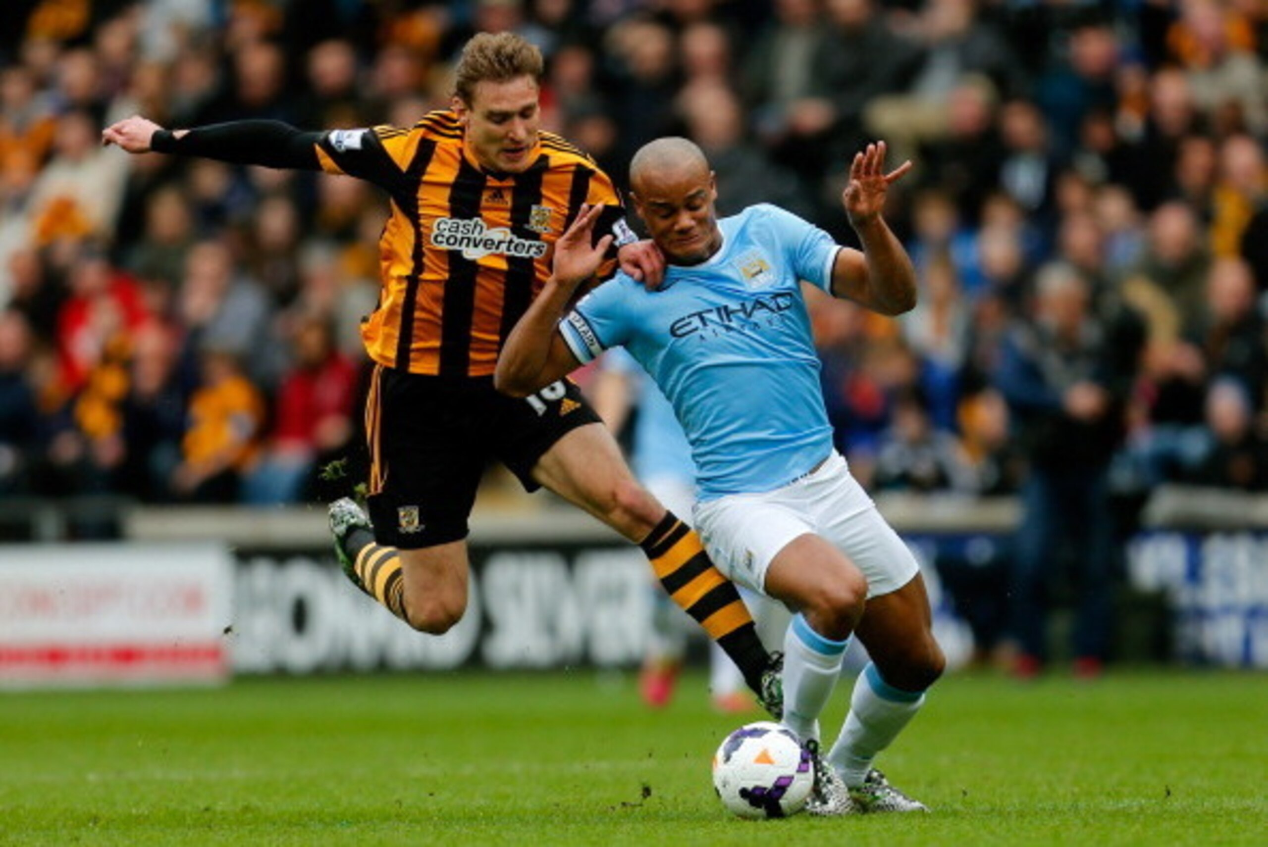 HULL, ENGLAND - MARCH 15:  Nikica Jelavic of Hull City clashes with Vincent Kompany of Manchester City during the Barclays Premier league match between Hull City and Manchester City at KC Stadium on March 15, 2014 in Hull, England. (Photo by Paul Thomas/G