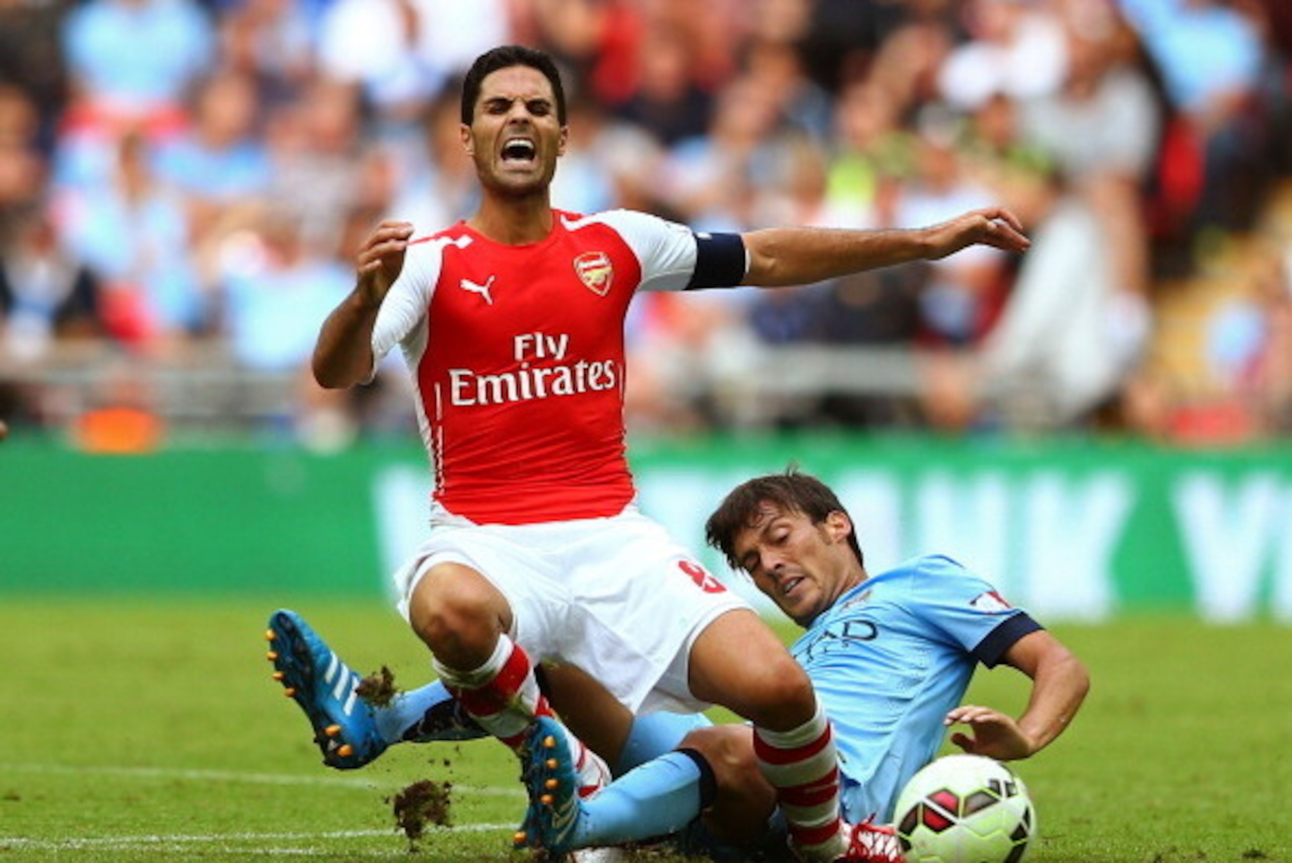 LONDON, ENGLAND - AUGUST 10: Mikel Arteta of Arsenal clashes with David Silva of Manchester City during the FA Community Shield match between Manchester City and Arsenal at Wembley Stadium on August 10, 2014 in London, England.  (Photo by Clive Mason/Gett