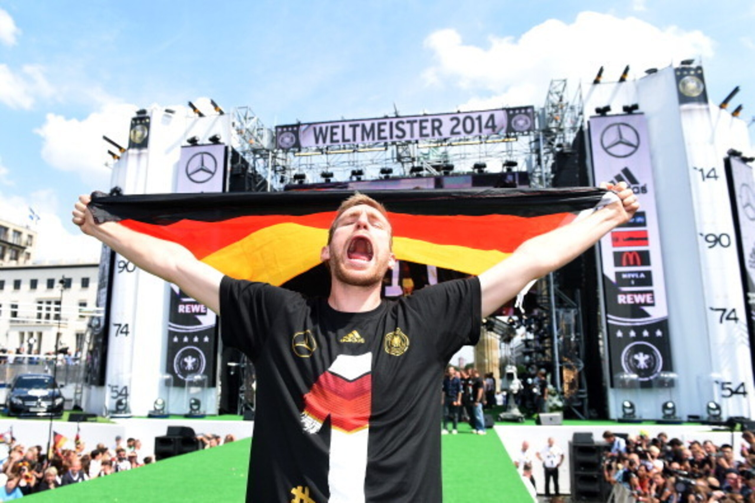 BERLIN, GERMANY - JULY 15:  Per Mertesacker celebrates during the German team victory ceremony on July 15, 2014 in Berlin, Germany. Germany won the 2014 FIFA World Cup Brazil match against Argentina in Rio de Janeiro on July 13.  (Photo by Markus Gilliar 