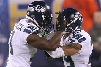 EAST RUTHERFORD, NJ - FEBRUARY 02:  Strong safety Kam Chancellor #31 of the Seattle Seahawks celebrates his interception with teammate free safety Earl Thomas #29 against the Denver Broncos in the first quarter during Super Bowl XLVIII at MetLife Stadium