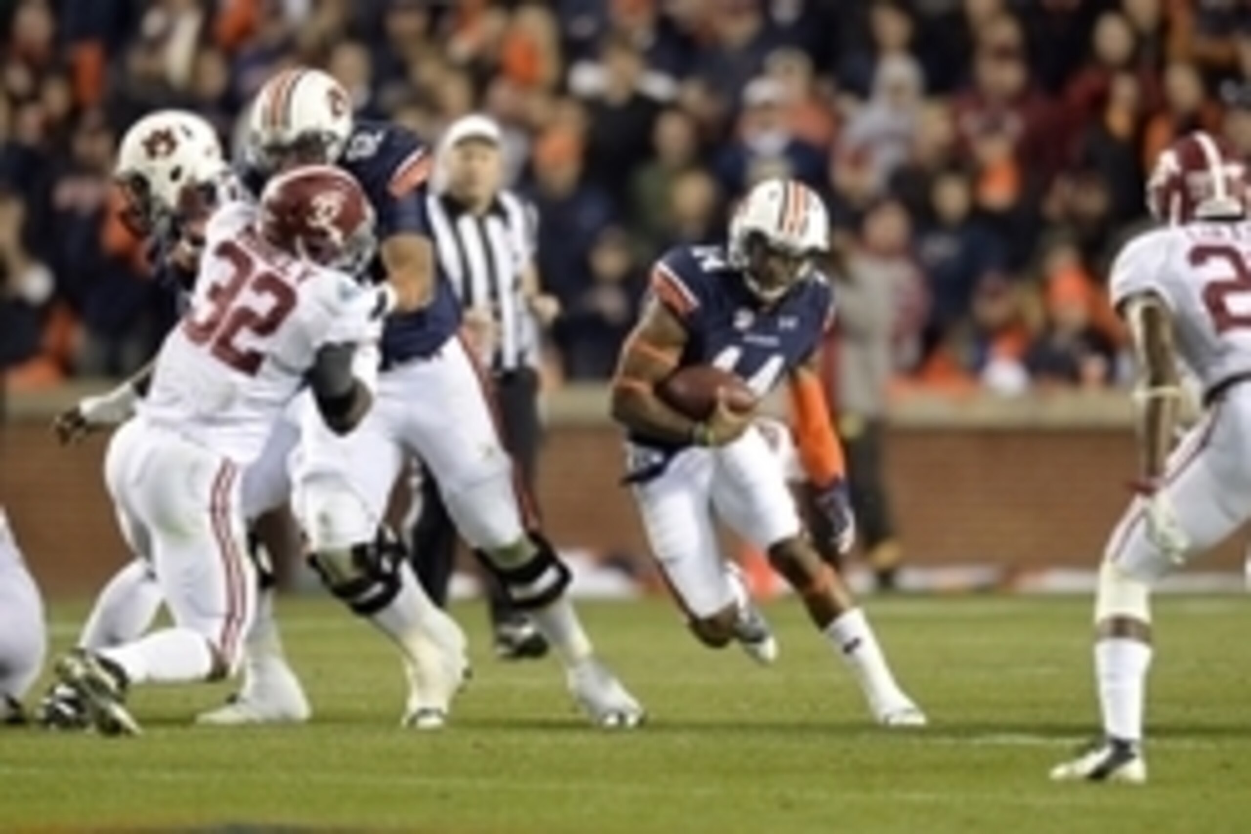 Nov 30, 2013; Auburn, AL, USA; Auburn Tigers quarterback Nick Marshall (14) runs against the Alabama Crimson Tide during the third quarter at Jordan Hare Stadium. Mandatory Credit: John David Mercer-USA TODAY Sports