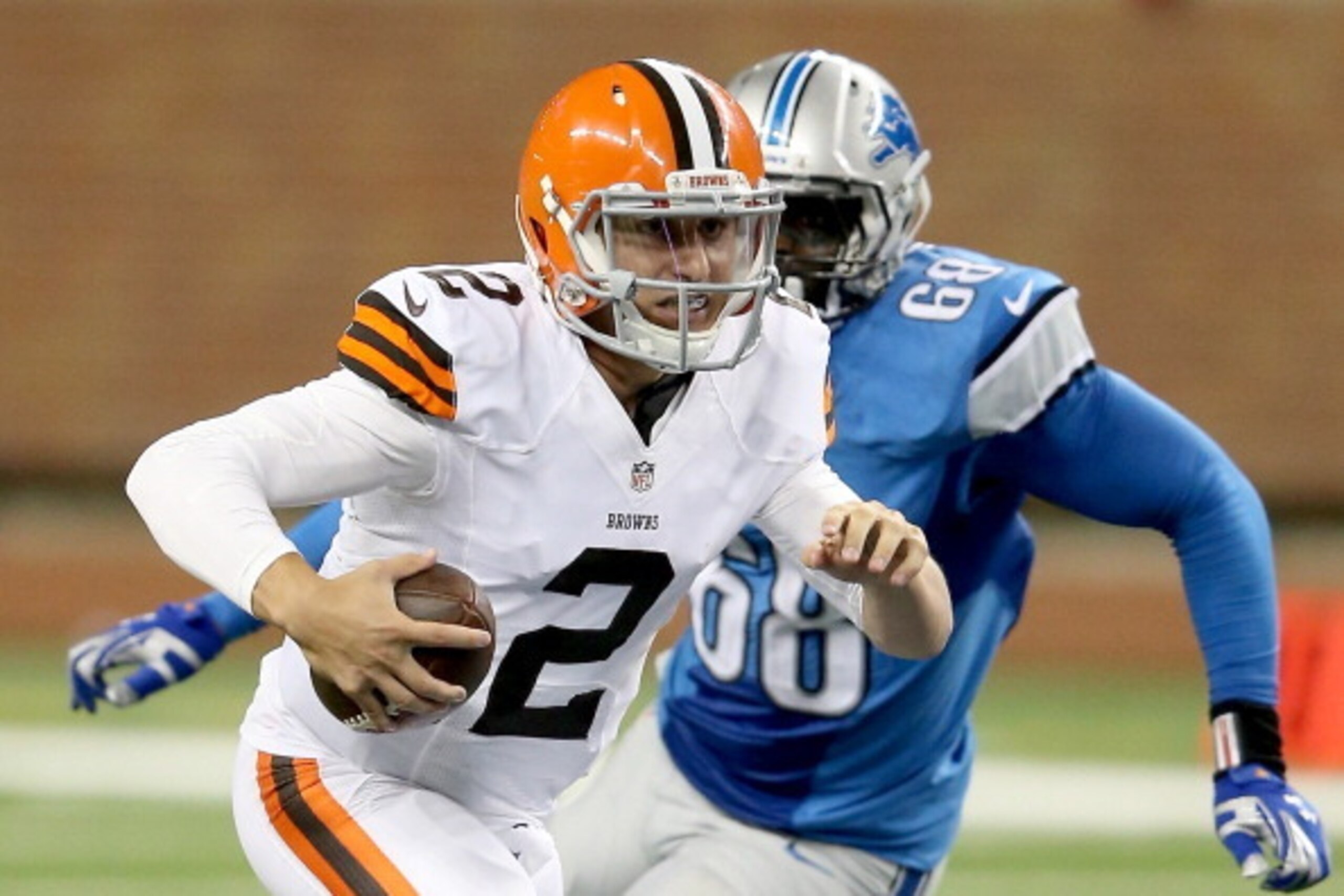 DETROIT, MI - AUGUST 09: Quarterback Johnny Manziel #2 of the Cleveland Browns tries to avoid the tackle by George Johnson #68 of the Detroit Lions in the third quarter during a preseason game at Ford Field on August 9, 2014 in Detroit, Michigan. (Phot DETROIT, MI - AUGUST 09: Quarterback Johnny Manziel #2 of the Cleveland Browns tries to avoid the tackle by George Johnson #68 of the Detroit Lions in the third quarter during a preseason game at Ford Field on August 9, 2014 in Detroit, Michigan. (Phot