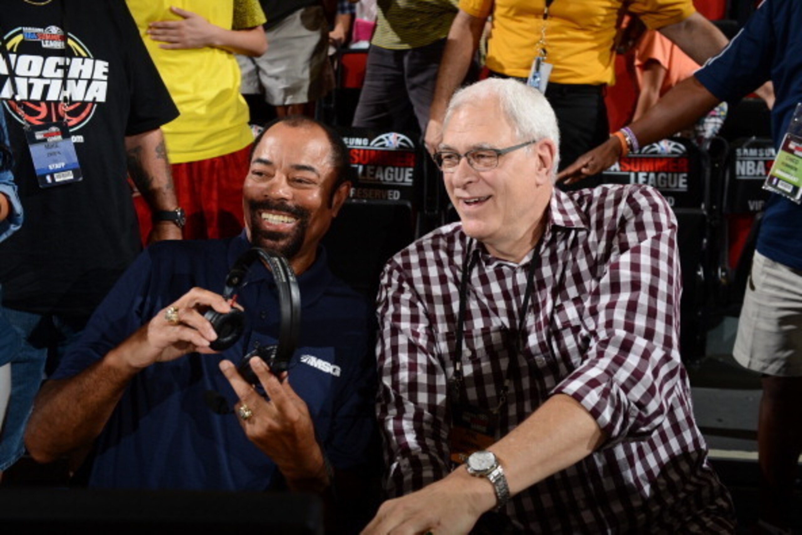 LAS VEGAS, NV - JULY 14:  (L-R) Commentator Walt Frazier and New York Knicks President Phil Jackson looks on during the Samsung NBA Summer League 2014 at the Cox Pavilion on July 14, 2014 in Las Vegas, Nevada. NOTE TO USER: User expressly acknowledges and