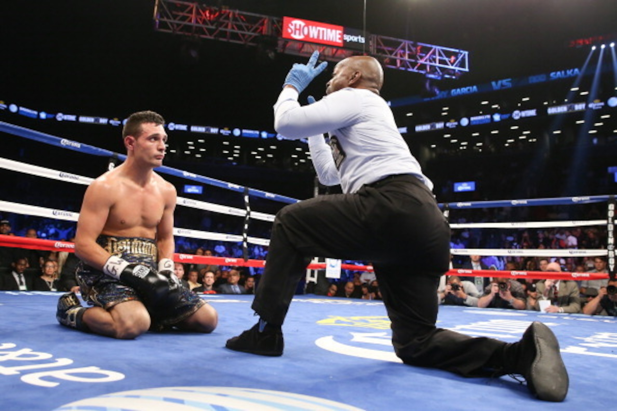BROOKLYN, NY - AUGUST 9: Referee Steve Willis counts after Rod Salka (Black/Gold trunks) was knocked down by Danny Garcia during their fight at the Barclays Center on August 9, 2014 in Brooklyn, New York. (Photo by Ed Mulholland/Getty Images)