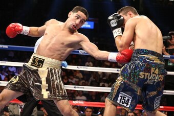 BROOKLYN, NY - AUGUST 9: Danny Garcia (Brown/Gold trunks) lands a left to the body of Rod Salka (Black/Gold trunks) during their fight at the Barclays Center on August 9, 2014 in Brooklyn, New York. (Photo by Ed Mulholland/Getty Images)