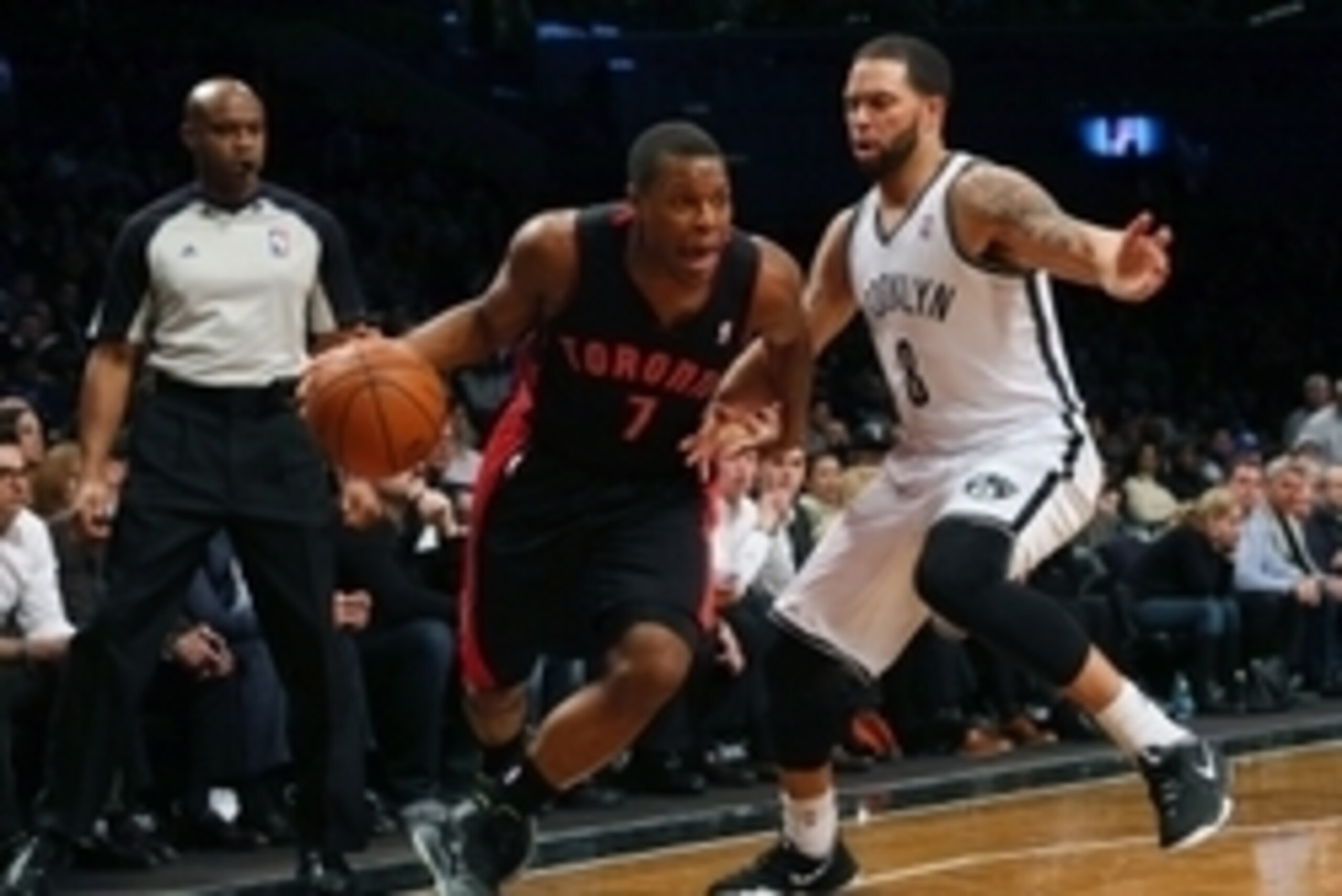 Mar 10, 2014; Brooklyn, NY, USA; Toronto Raptors point guard Kyle Lowry (7) drives past Brooklyn Nets point guard Deron Williams (8) during the first quarter at the Barclays Center. Mandatory Credit: Adam Hunger-USA TODAY Sports