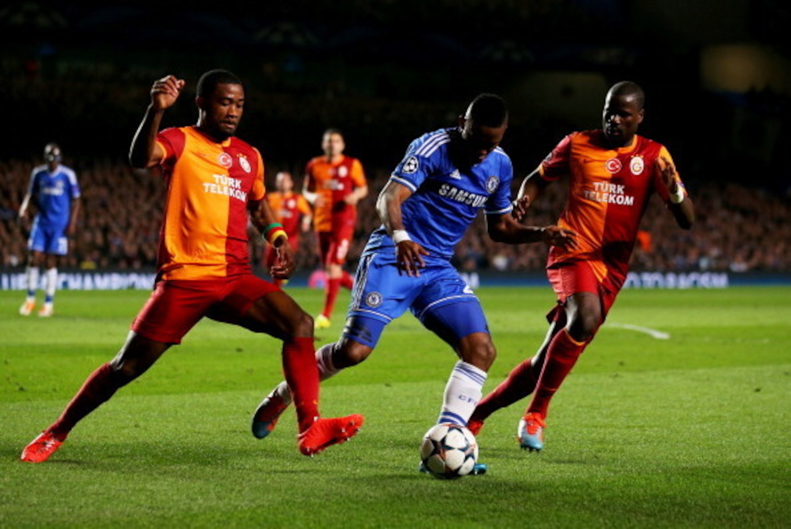 LONDON, ENGLAND - MARCH 18:  Samuel Eto'o of Chelsea is marshalled by Aurelien Chedjou (L) and Emmanuel Eboue of Galatasaray (R) during the UEFA Champions League Round of 16 second leg match between Chelsea and Galatasaray AS at Stamford Bridge on March 1