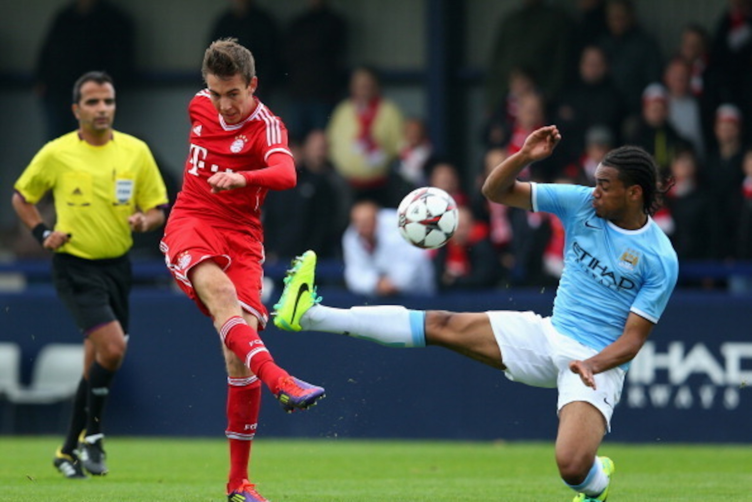MANCHESTER, ENGLAND - OCTOBER 02: Michael Eberwein of FC Bayern Muenchen shoots as Jason Denayer of Manchester City tries to block during the UEFA Youth Champions League match between Manchester City and FC Bayern Muenchen at Ewen Fields on October 2, 20 MANCHESTER, ENGLAND - OCTOBER 02: Michael Eberwein of FC Bayern Muenchen shoots as Jason Denayer of Manchester City tries to block during the UEFA Youth Champions League match between Manchester City and FC Bayern Muenchen at Ewen Fields on October 2, 20