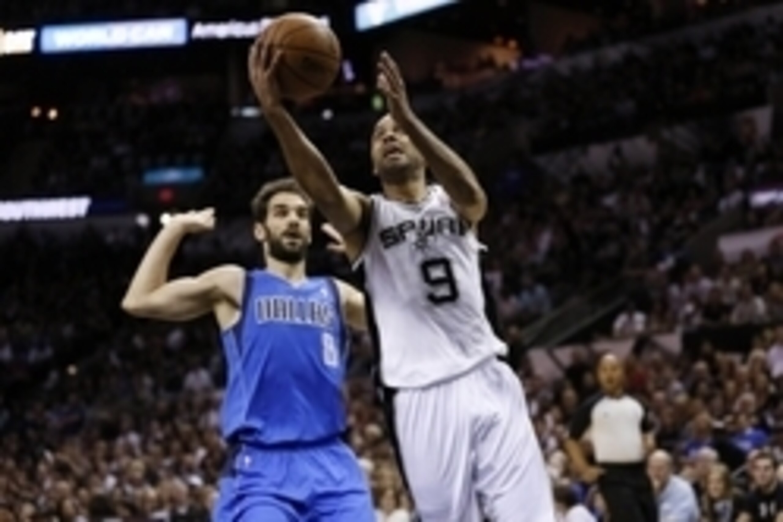 May 4, 2014; San Antonio, TX, USA; San Antonio Spurs guard Tony Parker (9) drives to the basket  past Dallas Mavericks guard Jose Calderon (left) in game seven of the first round of the 2014 NBA Playoffs at AT&T Center. Mandatory Credit: Soobum Im-USA TOD