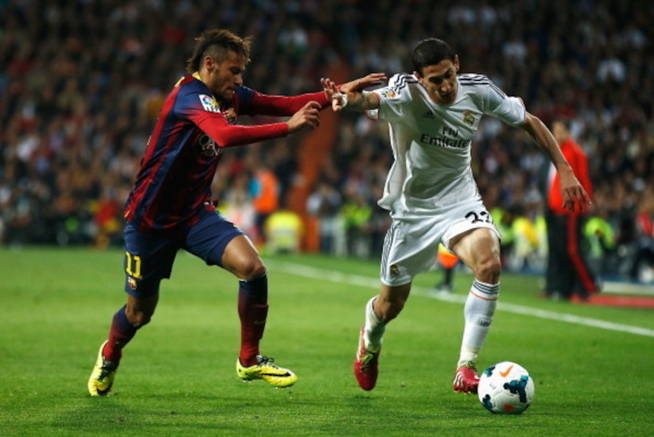 MADRID, SPAIN - MARCH 23:  Angel Di Maria of Real Madrid is challenged by Neymar of Barcelona during the La Liga match between Real Madrid CF and FC Barcelona at the Bernabeu on March 23, 2014 in Madrid, Spain.  (Photo by Gonzalo Arroyo Moreno/Getty Image