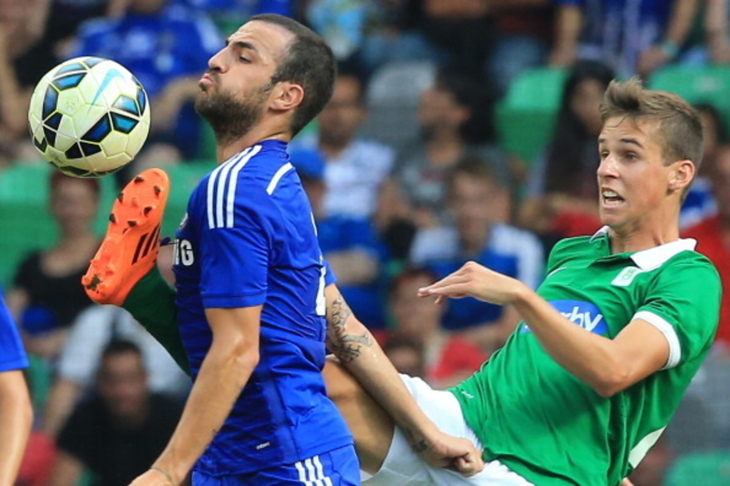 LJUBLJANA, SLOVENIA - JULY 27: Cesc Fabregas of Chelsea is challenged by Nik Kapunik (R) of Olimpija Ljubljana during the Pre Season Friendly match between FC Olimpija Ljubljana and Chelsea at Stozice stadium in Ljubljana, Slovenia on Sunday, July 27, 20 LJUBLJANA, SLOVENIA - JULY 27: Cesc Fabregas of Chelsea is challenged by Nik Kapunik (R) of Olimpija Ljubljana during the Pre Season Friendly match between FC Olimpija Ljubljana and Chelsea at Stozice stadium in Ljubljana, Slovenia on Sunday, July 27, 20
