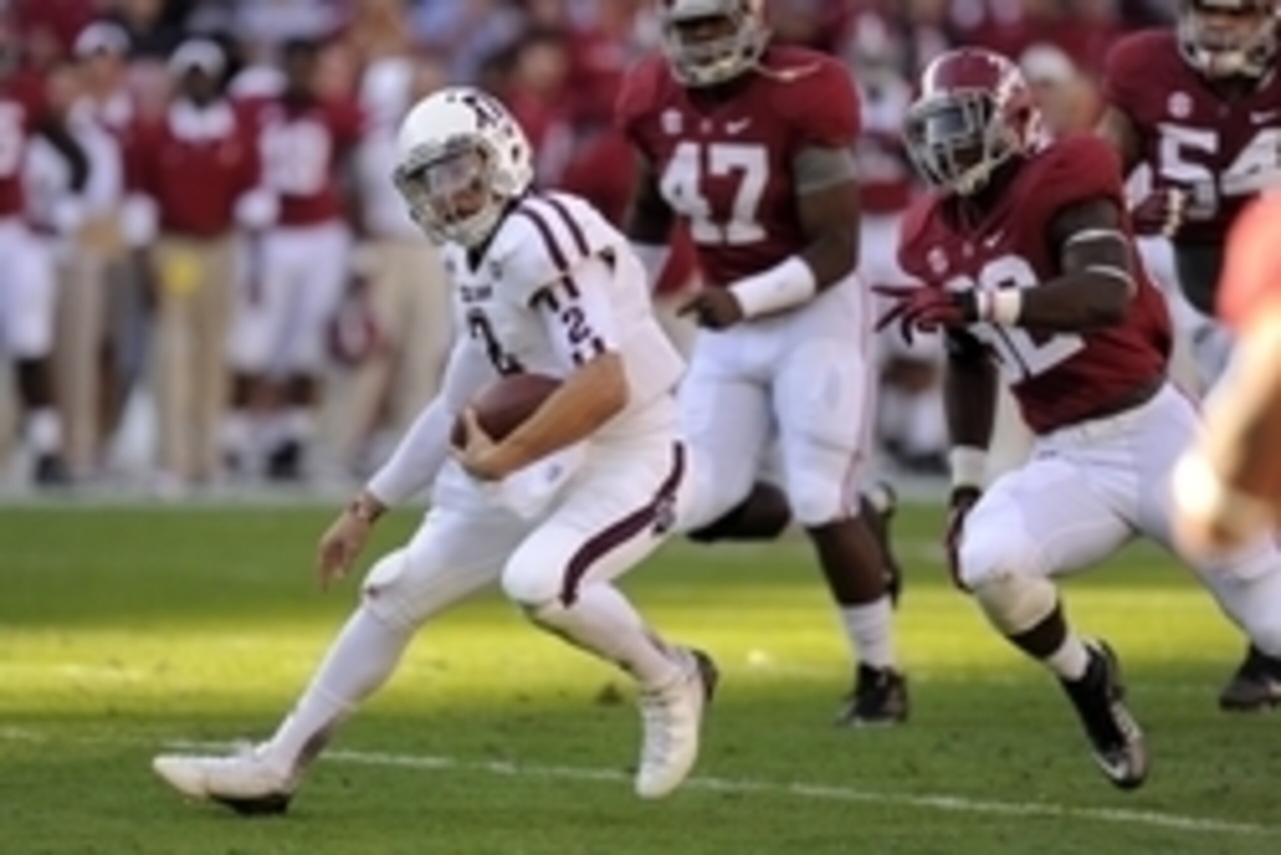 November 10, 2012; Tuscaloosa, AL, USA;  Texas A&M Aggies quarterback Johnny Manziel (2) carries through the Alabama Crimson Tide defense during the first quarter at Bryant Denny Stadium. Mandatory Credit: John David Mercer-USA TODAY Sports