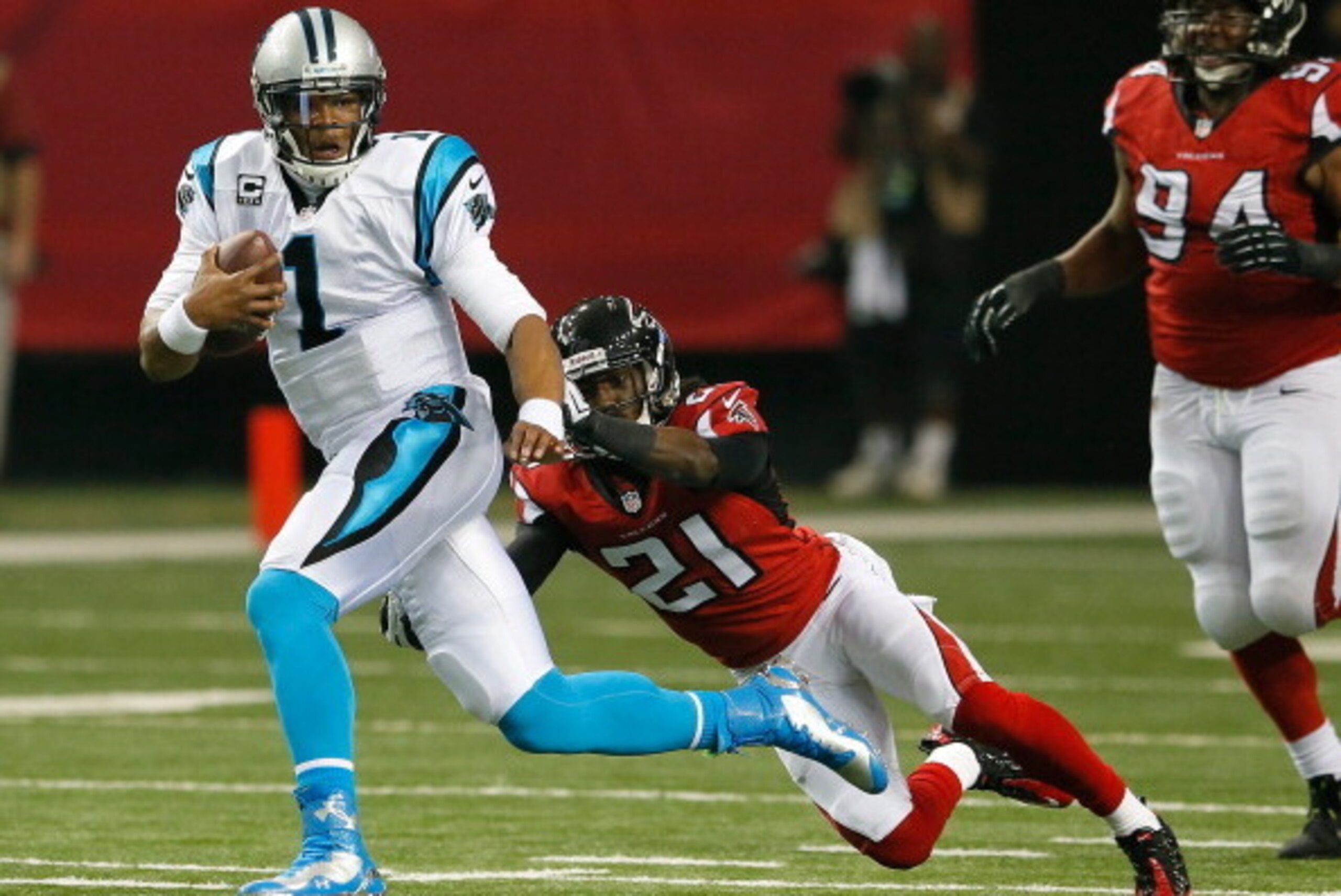 ATLANTA, GA - DECEMBER 29:  Cam Newton #1 of the Carolina Panthers rushes against Desmond Trufant #21 of the Atlanta Falcons at Georgia Dome on December 29, 2013 in Atlanta, Georgia.  (Photo by Kevin C. Cox/Getty Images)