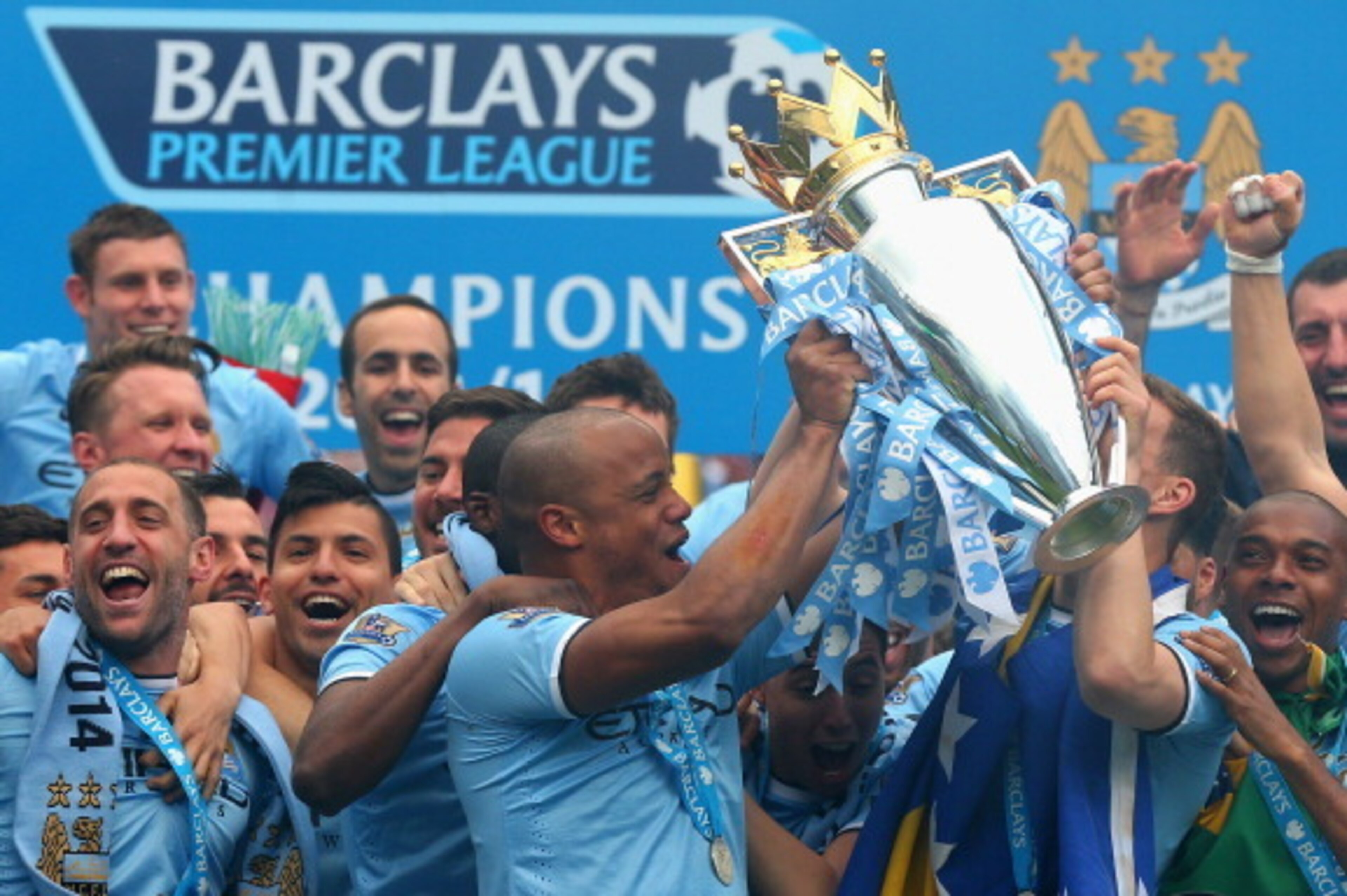 MANCHESTER, ENGLAND - MAY 11:  Vincent Kompany of Manchester City lifts the Premier League trophy at the end of the Barclays Premier League match between Manchester City and West Ham United at the Etihad Stadium on May 11, 2014 in Manchester, England.  (P