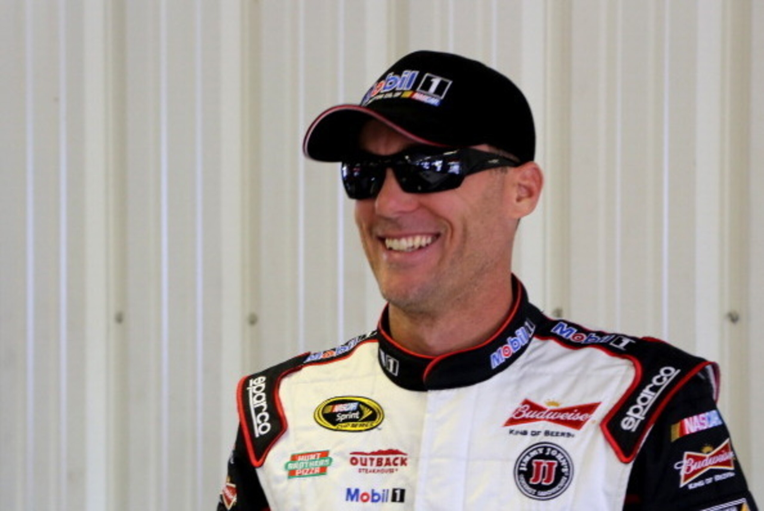LONG POND, PA - AUGUST 02:  Kevin Harvick, driver of the #4 Mobil 1 Chevrolet, smiles from in the garage during practice for the NASCAR Sprint Cup Series GoBowling.com 400 at Pocono Raceway on August 2, 2014 in Long Pond, Pennsylvania.  (Photo by Jerry Ma