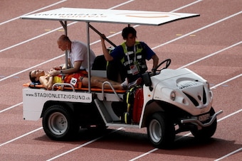 ZURICH, SWITZERLAND - AUGUST 12:  Victor Garcia of Spain is given assistance as he falls at the final hurdle in the Men's 3000 metres Steeplechase heats during day one of the 22nd European Athletics Championships at Stadium Letzigrund on August 12, 2014 i