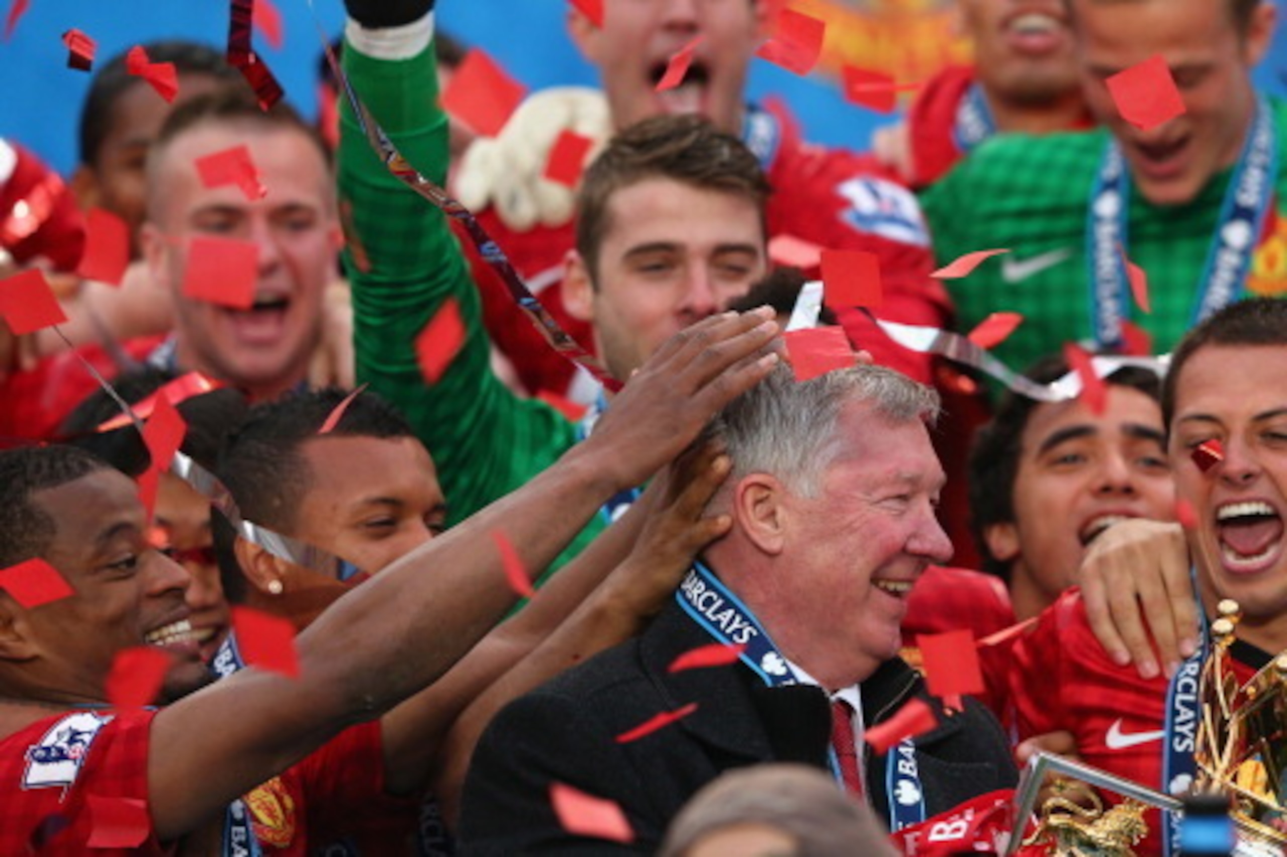 MANCHESTER, ENGLAND - MAY 12:  Manchester United Manager Sir Alex Ferguson celebrates with his players and the Premier League trophy following the Barclays Premier League match between Manchester United and Swansea City at Old Trafford on May 12, 2013 in 