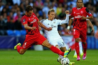 CARDIFF, WALES - AUGUST 12:  Grzegorz Krychowiak of Sevilla and Luka Modric of Real Madrid battle for the ball during the UEFA Super Cup between Real Madrid and Sevilla FC at Cardiff City Stadium on August 12, 2014 in Cardiff, Wales.  (Photo by Clive Maso