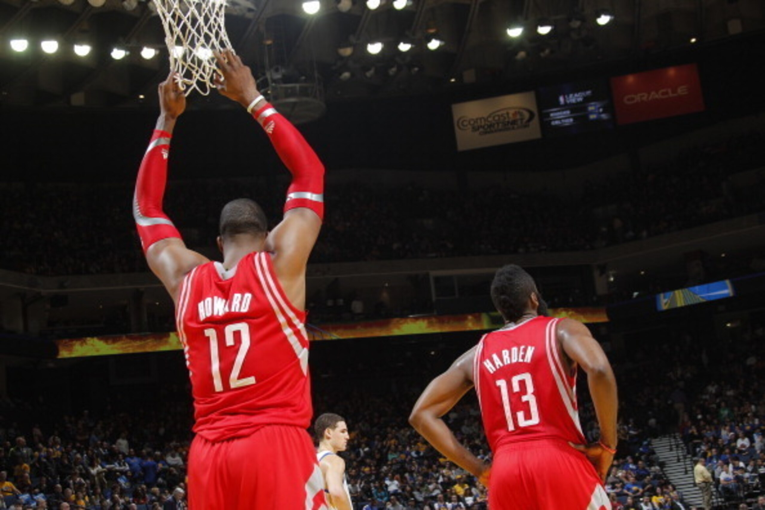 OAKLAND, CA - DECEMBER 13: James Harden #13 with Dwight Howard #12 of the Houston Rockets hangs from the net during a game against the Golden State Warriors on December 13, 2013 at Oracle Arena in Oakland, California. NOTE TO USER: User expressly acknowle