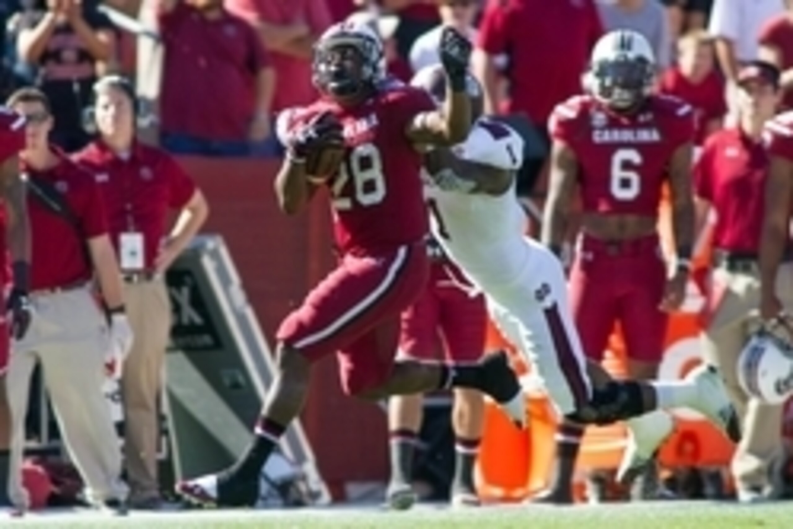 Nov 2, 2013; Columbia, SC, USA; South Carolina Gamecocks running back Mike Davis (28) runs the ball while being pursued by Mississippi State Bulldogs defensive back Nickoe Whitley (1) during the third quarter at Williams-Brice Stadium. The Gamecocks defea