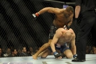 Feb 22, 2014; Las Vegas, NV, USA;  Daniel Cormier (red gloves) tries to land a punch from above on Patrick Cummins (blue gloves) during their UFC light heavyweight bout at Mandalay Bay. Cormier won by way of a TKO in the first round. Mandatory Credit: Ste