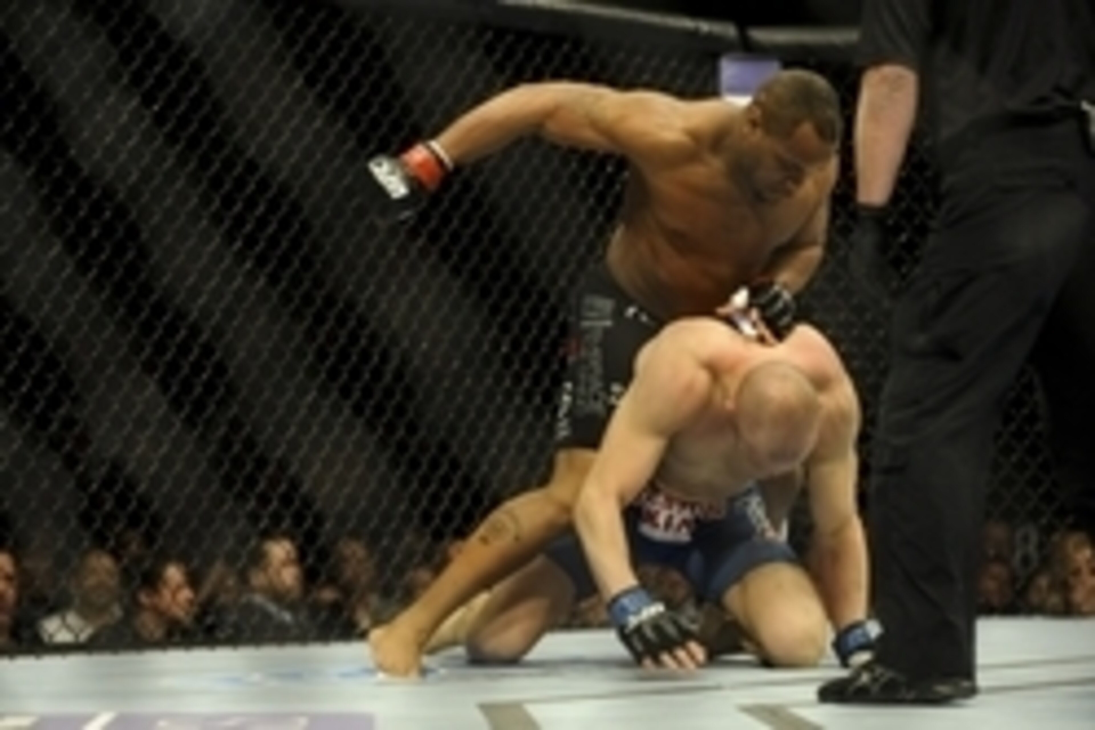 Feb 22, 2014; Las Vegas, NV, USA; Daniel Cormier (red gloves) tries to land a punch from above on Patrick Cummins (blue gloves) during their UFC light heavyweight bout at Mandalay Bay. Cormier won by way of a TKO in the first round. Mandatory Credit: Ste Feb 22, 2014; Las Vegas, NV, USA; Daniel Cormier (red gloves) tries to land a punch from above on Patrick Cummins (blue gloves) during their UFC light heavyweight bout at Mandalay Bay. Cormier won by way of a TKO in the first round. Mandatory Credit: Ste