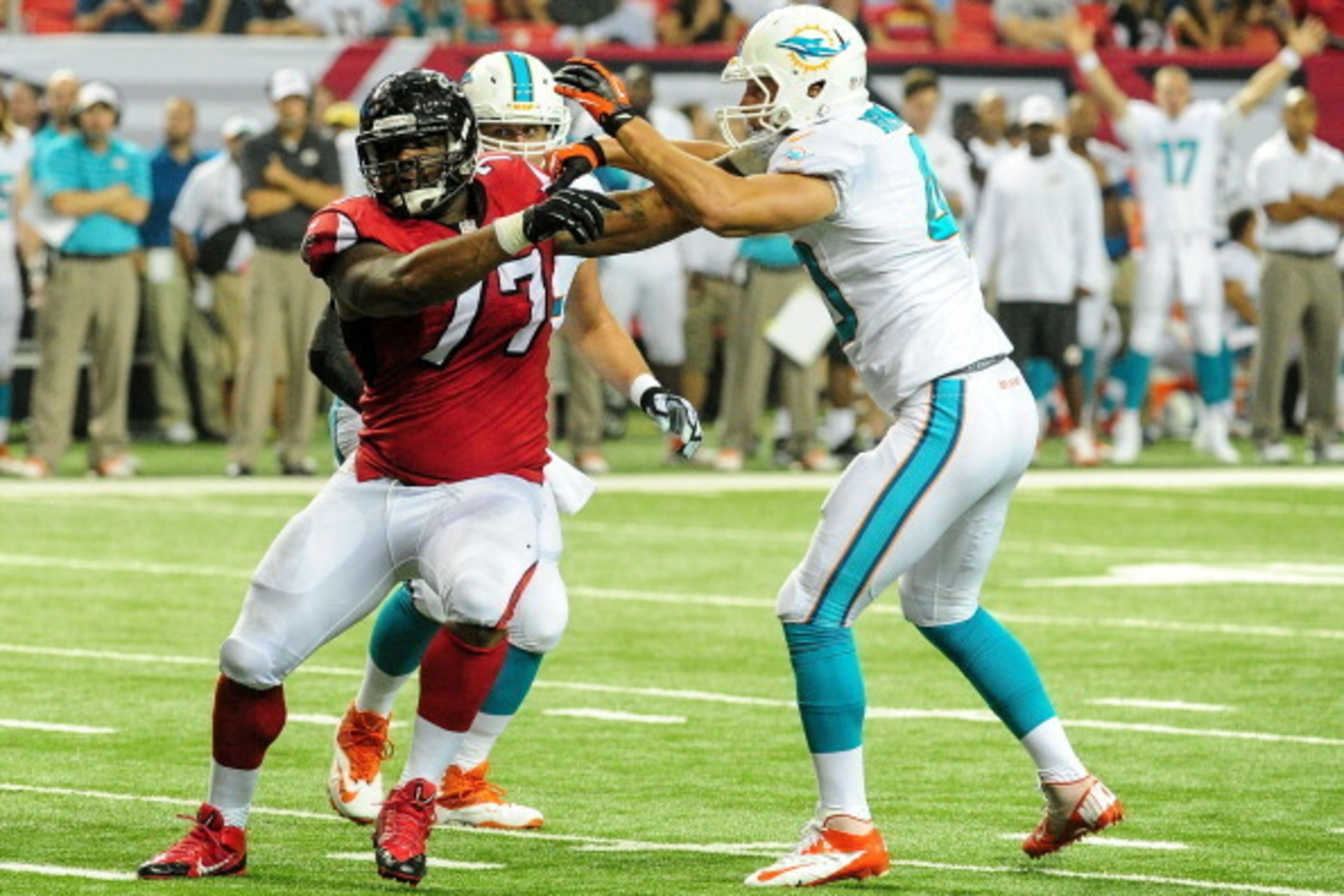 ATLANTA, GA - AUGUST 08: Ra'Shede Hageman #77 of the Atlanta Falcons pushes past Brett Brackett #40 of the Miami Dolphins in the fourth quarter of a preseason game at the Georgia Dome on August 8, 2014 in Atlanta, Georgia. The Falcons won 16-10. (Photo by