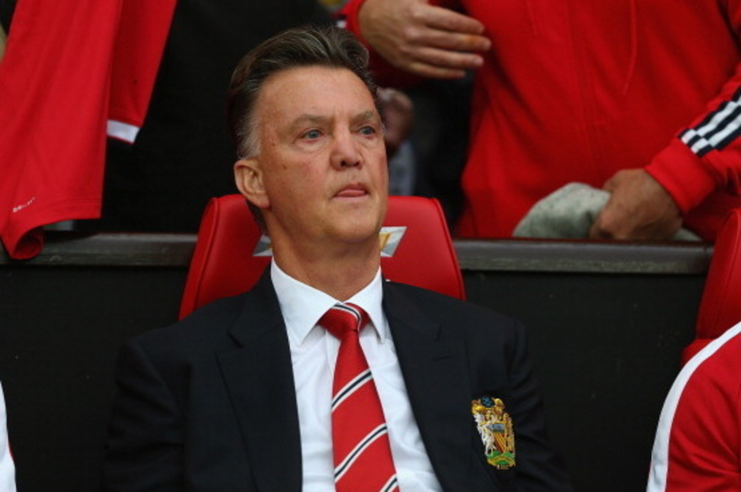 MANCHESTER, ENGLAND - AUGUST 12: Manchester United manager Louis Van Gaal sits on the team bench as he makes his home debut during the Pre Season Friendly match between Manchester United and Valencia at Old Trafford on August 12, 2014 in Manchester, Engl MANCHESTER, ENGLAND - AUGUST 12: Manchester United manager Louis Van Gaal sits on the team bench as he makes his home debut during the Pre Season Friendly match between Manchester United and Valencia at Old Trafford on August 12, 2014 in Manchester, Engl