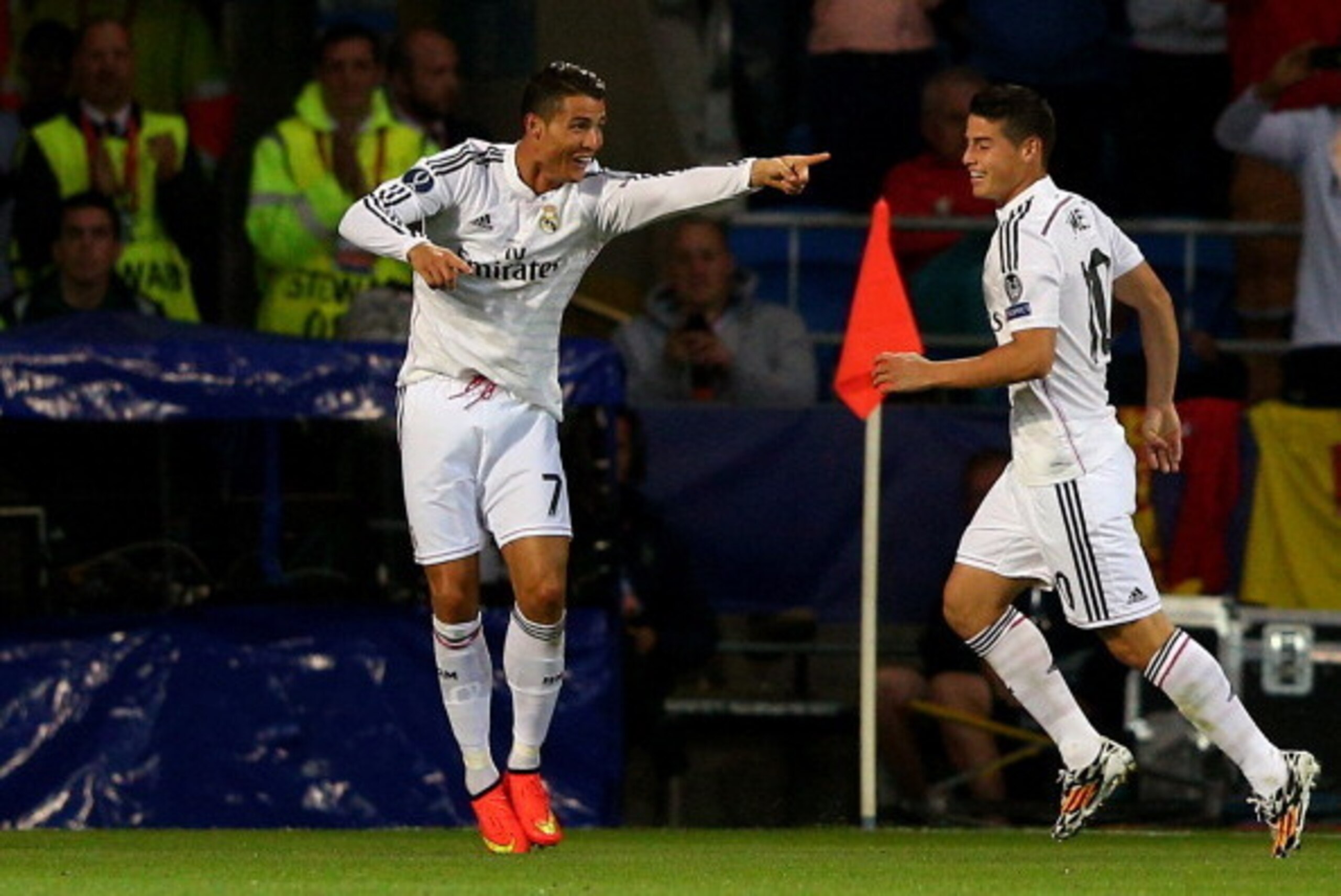 CARDIFF, WALES - AUGUST 12:  (L-R) Cristiano Ronaldo of Real Madrid celebrates with teammate James Rodriguez after scoring their team's second goal during the UEFA Super Cup between Real Madrid and Sevilla FC at Cardiff City Stadium on August 12, 2014 in 
