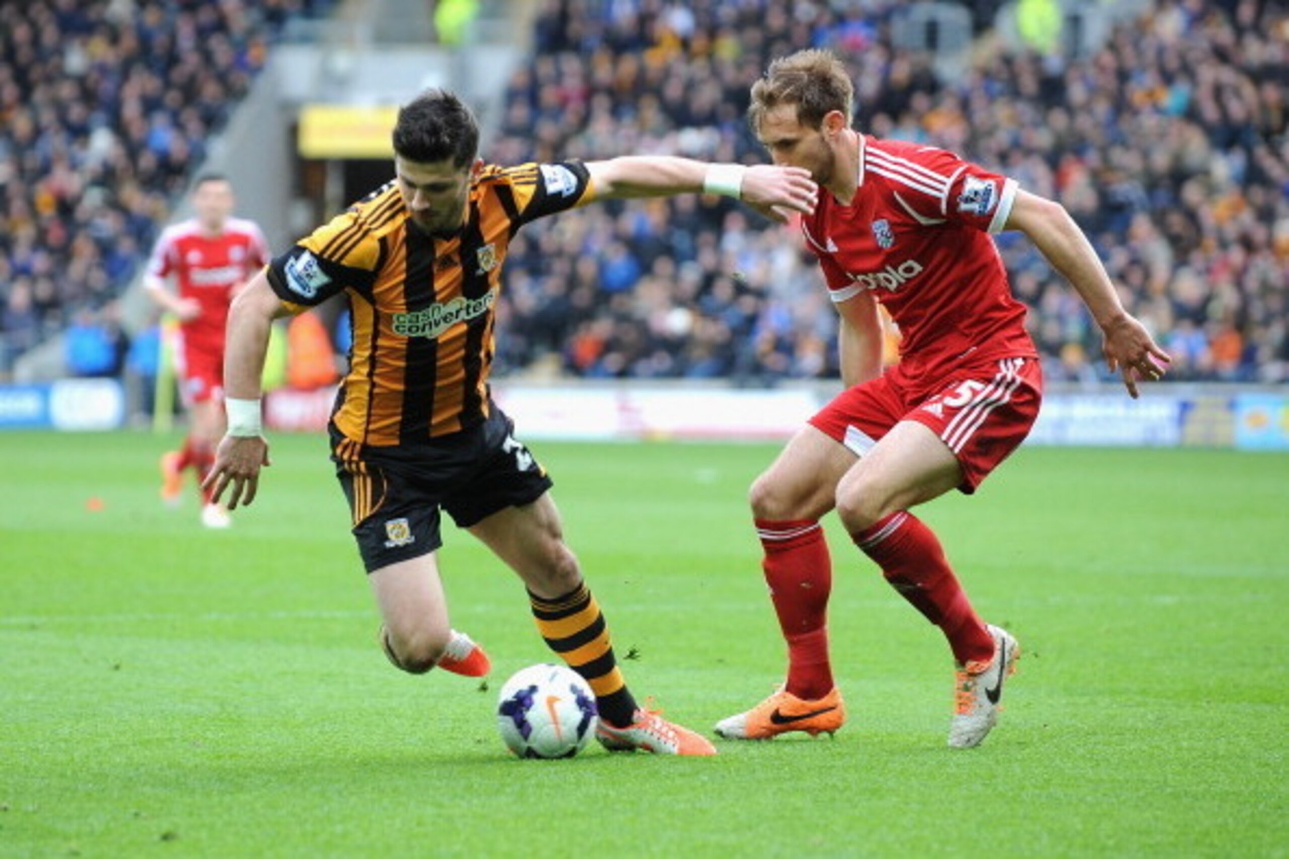 HULL, ENGLAND - MARCH 22: Shane Long of Hull City tackled by Craig Dawson of West Bromwich Albion during the Barclays Premier League match between Hull City and West Bromwich Albion at KC Stadium on March 22, 2014 in Hull, England. (Photo by Tony Marshal HULL, ENGLAND - MARCH 22: Shane Long of Hull City tackled by Craig Dawson of West Bromwich Albion during the Barclays Premier League match between Hull City and West Bromwich Albion at KC Stadium on March 22, 2014 in Hull, England. (Photo by Tony Marshal