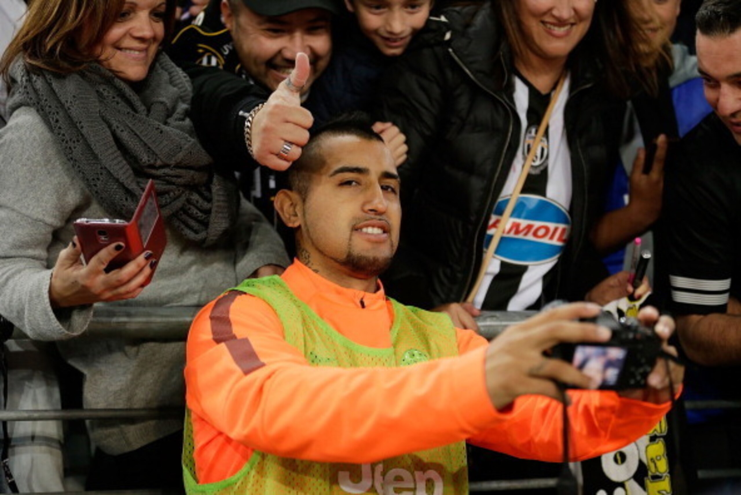 SYDNEY, AUSTRALIA - AUGUST 10:  Arturo Vidal of Juventus takes a photo with fans after the match between the A-League All Stars and Juventus at ANZ Stadium on August 10, 2014 in Sydney, Australia.  (Photo by Mark Metcalfe/Getty Images)