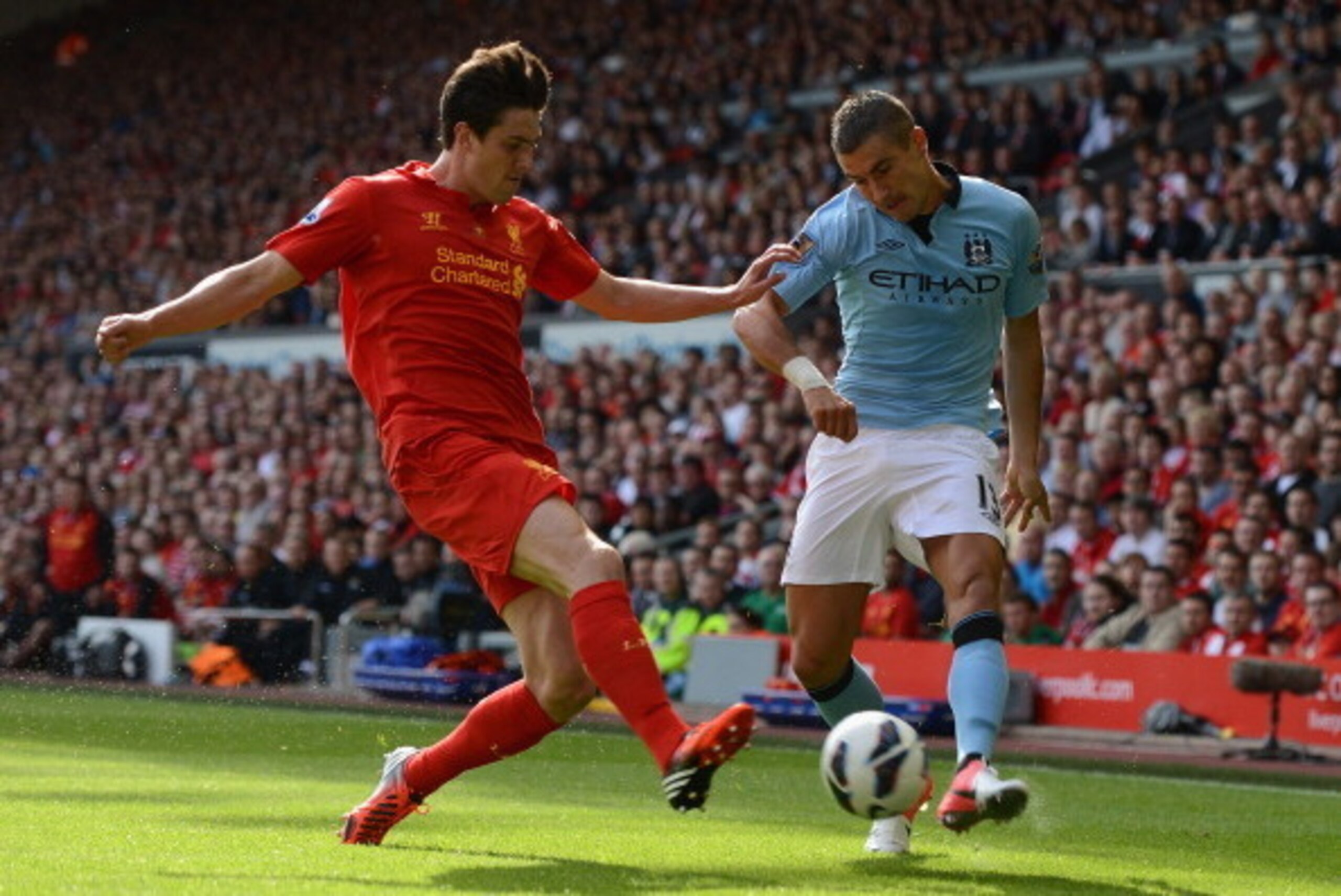 LIVERPOOL, ENGLAND - AUGUST 26:  Aleksandar Kolarov of Manchester City competes with Martin Kelly of Liverpool during the Barclays Premier League match between Liverpool and Manchester City at Anfield on August 26, 2012 in Liverpool, England.  (Photo by M