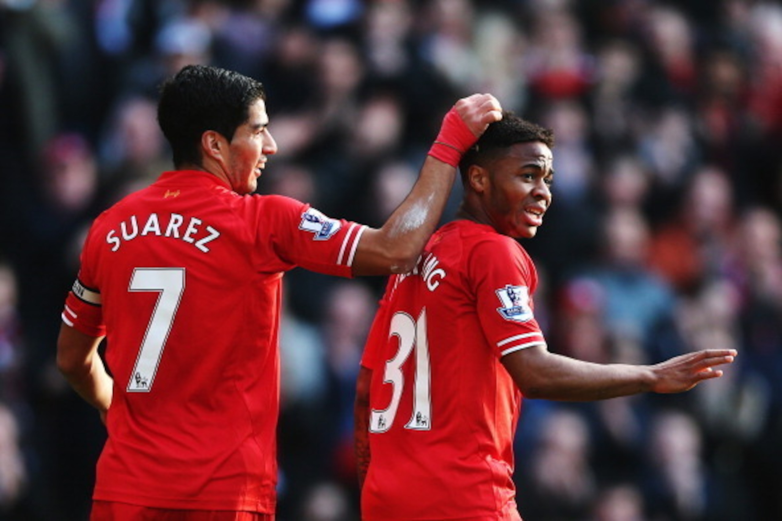 LIVERPOOL, ENGLAND - DECEMBER 21:  (L-R) Luis Suarez and Raheem Sterling of Liverpool react during the Barclays Premier League match between Liverpool and Cardiff City at Anfield on December 21, 2013 in Liverpool, England.  (Photo by Clive Brunskill/Getty