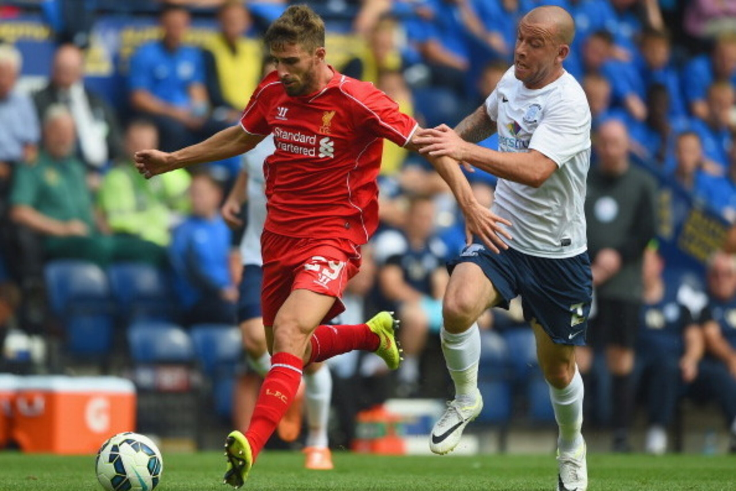 PRESTON, LANCASHIRE - JULY 19:  Keith Keane of Preston in action with Fabio Borini of Liverpool during the pre season friendly match between Preston North End and Liverpool at Deepdale on July 19, 2014 in Preston, Lancashire.  (Photo by Michael Regan/Gett