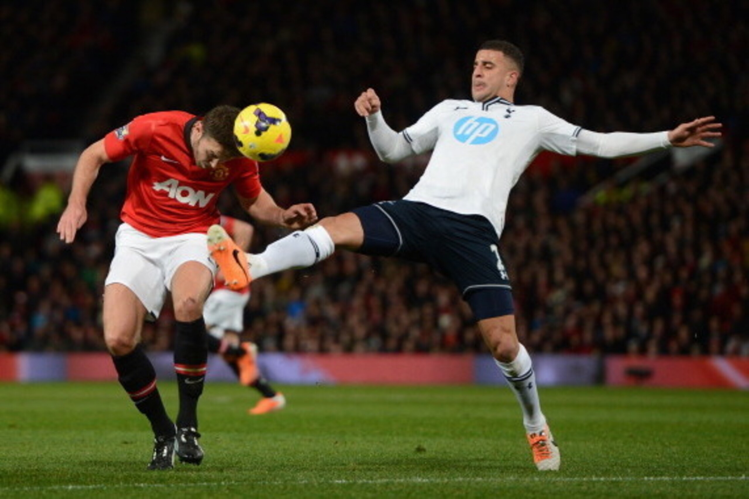MANCHESTER, ENGLAND - JANUARY 01:  Kyle Walker of Tottenham Hotspur challenges Michael Carrick of Manchester United during the Barclays Premier League match between Manchester United and Tottenham Hotspur at Old Trafford on January 1, 2014 in Manchester, 