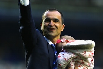 LIVERPOOL, ENGLAND - MAY 03:  Manager Roberto Martinez of Everton waves to the fans with his daughter at the end of the Barclays Premier League match between Everton and Manchester City at Goodison Park on May 3, 2014 in Liverpool, England.  (Photo by Cli