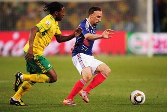 BLOEMFONTEIN, SOUTH AFRICA - JUNE 22: MacBeth Sibaya of South Africa challenges Franck Ribery of France during the 2010 FIFA World Cup South Africa Group A match between France and South Africa at the Free State Stadium on June 22, 2010 in Mangaung/Bloemf