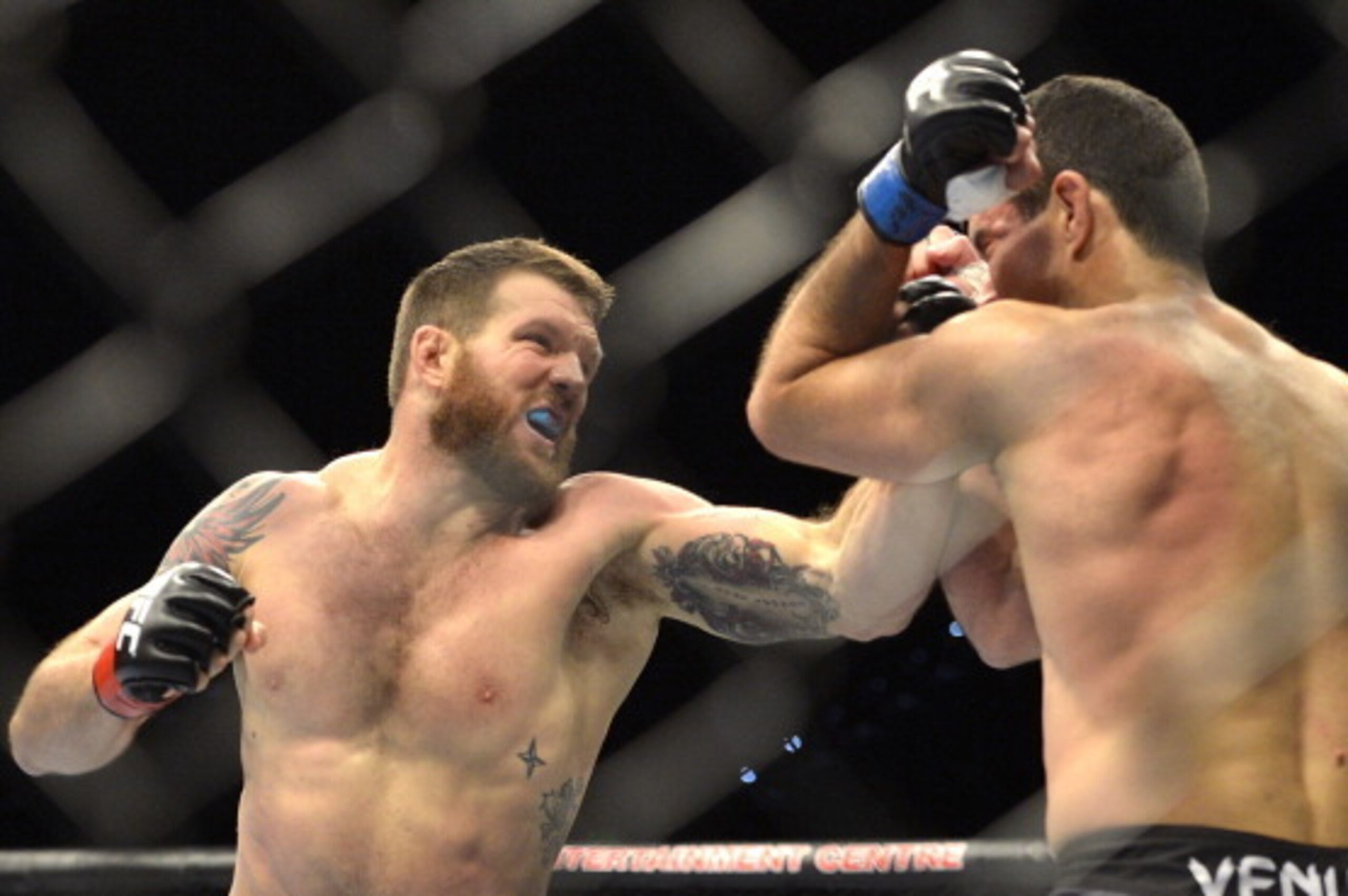 BRISBANE, AUSTRALIA - DECEMBER 07:  Ryan Bader of the USA punches Anthony Perosh of Australia during their UFC Fight Night Brisbane bout at the Brisbane Entertainment Centre on December 7, 2013 in Brisbane, Australia.   (Photo by Bradley Kanaris/Getty Ima