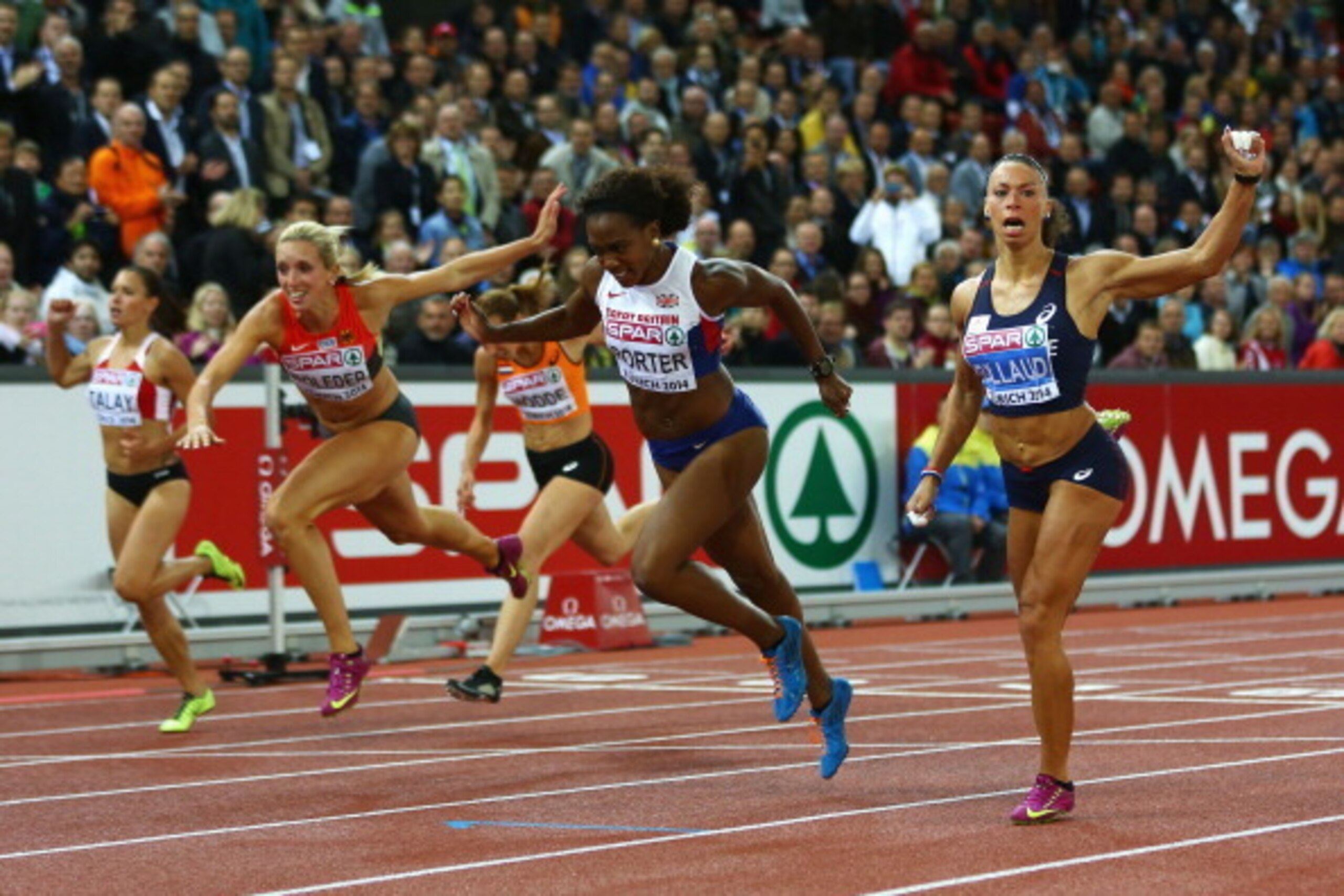ZURICH, SWITZERLAND - AUGUST 13: Gold medalist Tiffany Porter of Great Britain and Northern Ireland crosses the finish line to claim gold ahead of silver medalist Cindy Billaud of France and bronze medalist Cindy Roleder of Germany in the women's 100m hu ZURICH, SWITZERLAND - AUGUST 13: Gold medalist Tiffany Porter of Great Britain and Northern Ireland crosses the finish line to claim gold ahead of silver medalist Cindy Billaud of France and bronze medalist Cindy Roleder of Germany in the women's 100m hu