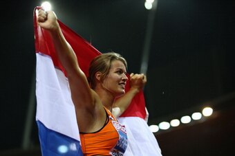 ZURICH, SWITZERLAND - AUGUST 13:  Dafne Schippers of the Netherlands celebrates with the Dutch national flag after claiming gold in the Women's 100 metres final during day two of the 22nd European Athletics Championships at Stadium Letzigrund on August 13