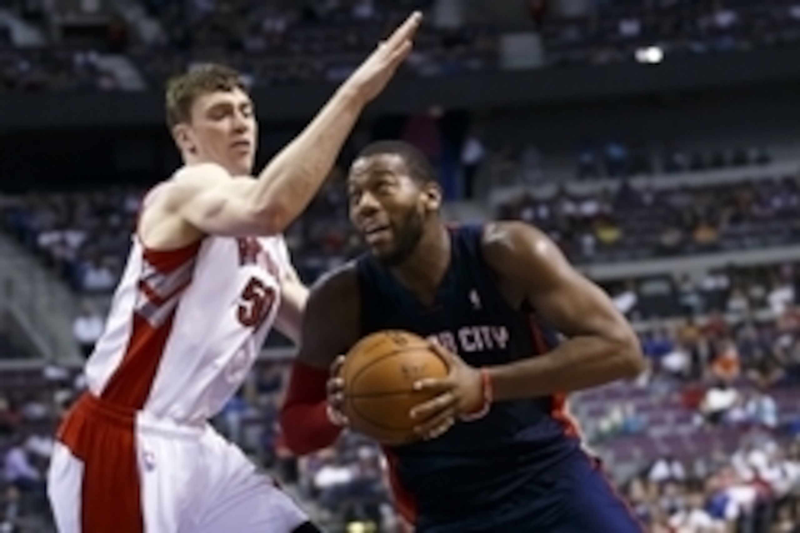Apr 13, 2014; Auburn Hills, MI, USA; Detroit Pistons forward Greg Monroe (10) dribbles around Toronto Raptors forward Tyler Hansbrough (50) in the fourth quarter at The Palace of Auburn Hills. Mandatory Credit: Rick Osentoski-USA TODAY Sports