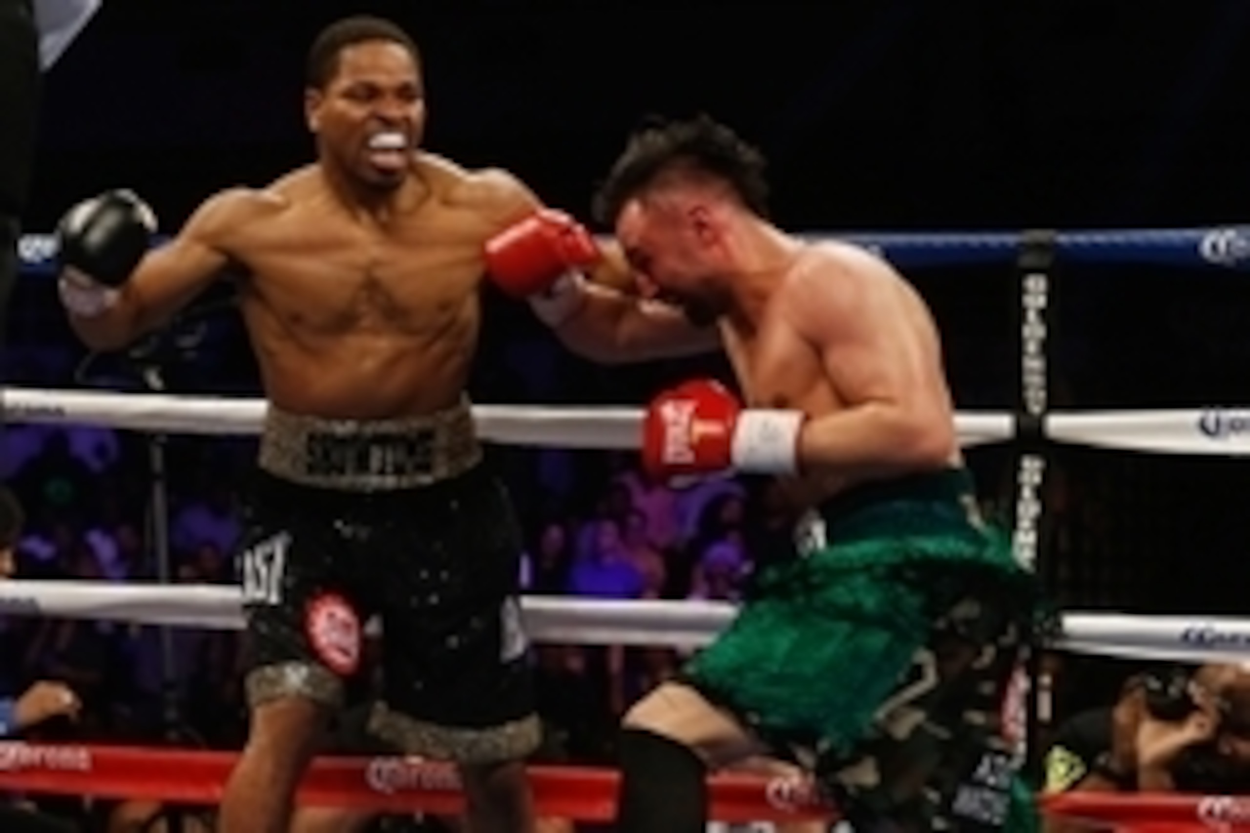 Apr 19, 2014; Washington, DC, USA; Shawn Porter (black gloves and Paulie Malignaggi (red gloves) in action during their bout at DC Armory. Mandatory Credit: Geoff Burke-USA TODAY Sports