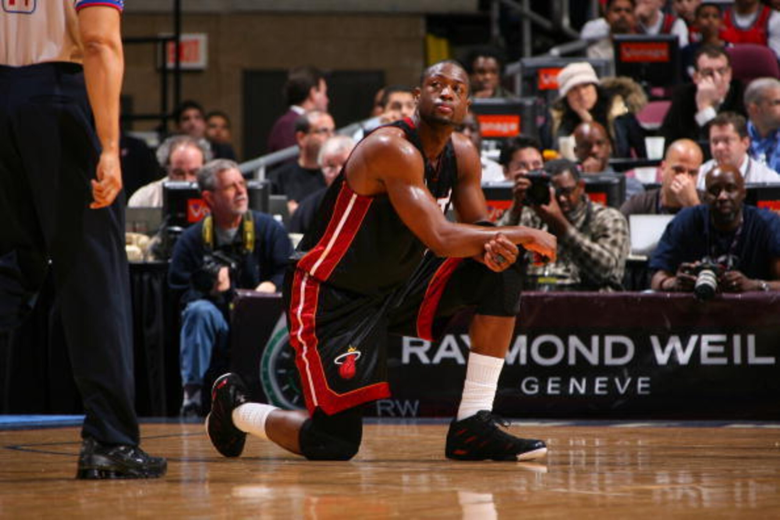 EAST RUTHERFORD,NJ - MARCH 20:  Dwyane Wade #3 of the Miami Heat takes a knee during the game against the New Jersey Nets on March 20, 2009 at the Izod Center in East Rutherford, New Jersey.  NOTE TO USER: User expressly acknowledges and agrees that, by d
