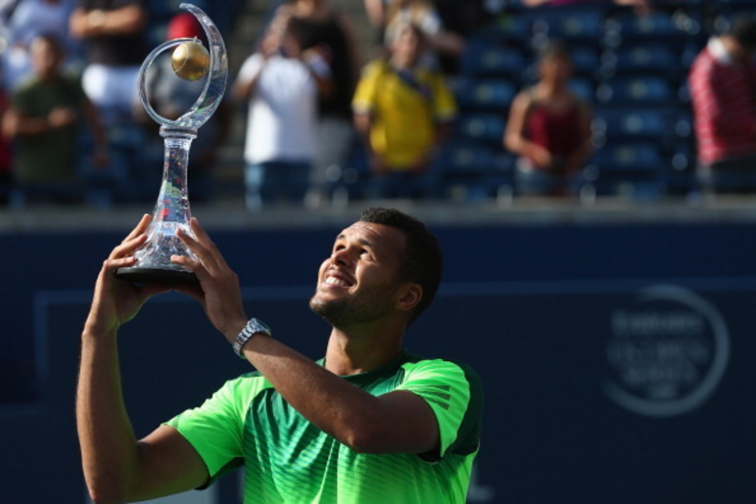TORONTO, ON - AUGUST 10:  Jo-Wilfried Tsonga of France holds up the Rogers Cup trophy after his win against Roger Federer of Switzerland during Rogers Cup at Rexall Centre at York University on August 10, 2014 in Toronto, Canada.  (Photo by Ronald Martine