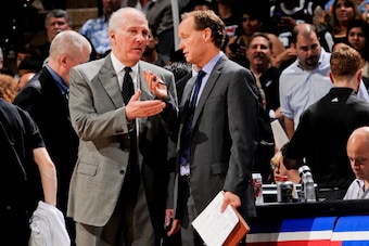 SAN ANTONIO, TX - JUNE 13: Head Coach Gregg Popovich of the San Antonio Spurs speaks with assistant coach Mike Budenholzer as the team plays the Miami Heat during Game Four of the 2013 NBA Finals on June 13, 2013 at AT&T Center in San Antonio, Texas. NOTE