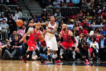 ATLANTA, GA - APRIL 2: Jeff Teague #0 of the Atlanta Hawks passes the ball against the Chicago Bulls on April 2, 2014 at Philips Arena in Atlanta, Georgia.  NOTE TO USER: User expressly acknowledges and agrees that, by downloading and/or using this Photog