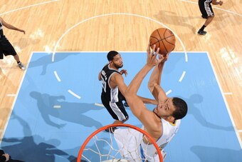 DENVER, CO - NOVEMBER 5: JaVale McGee #34 of the Denver Nuggets goes up for the reverse dunk against the San Antonio Spurs on November 5, 2013 at the Pepsi Center in Denver, Colorado. NOTE TO USER: User expressly acknowledges and agrees that, by downloadi