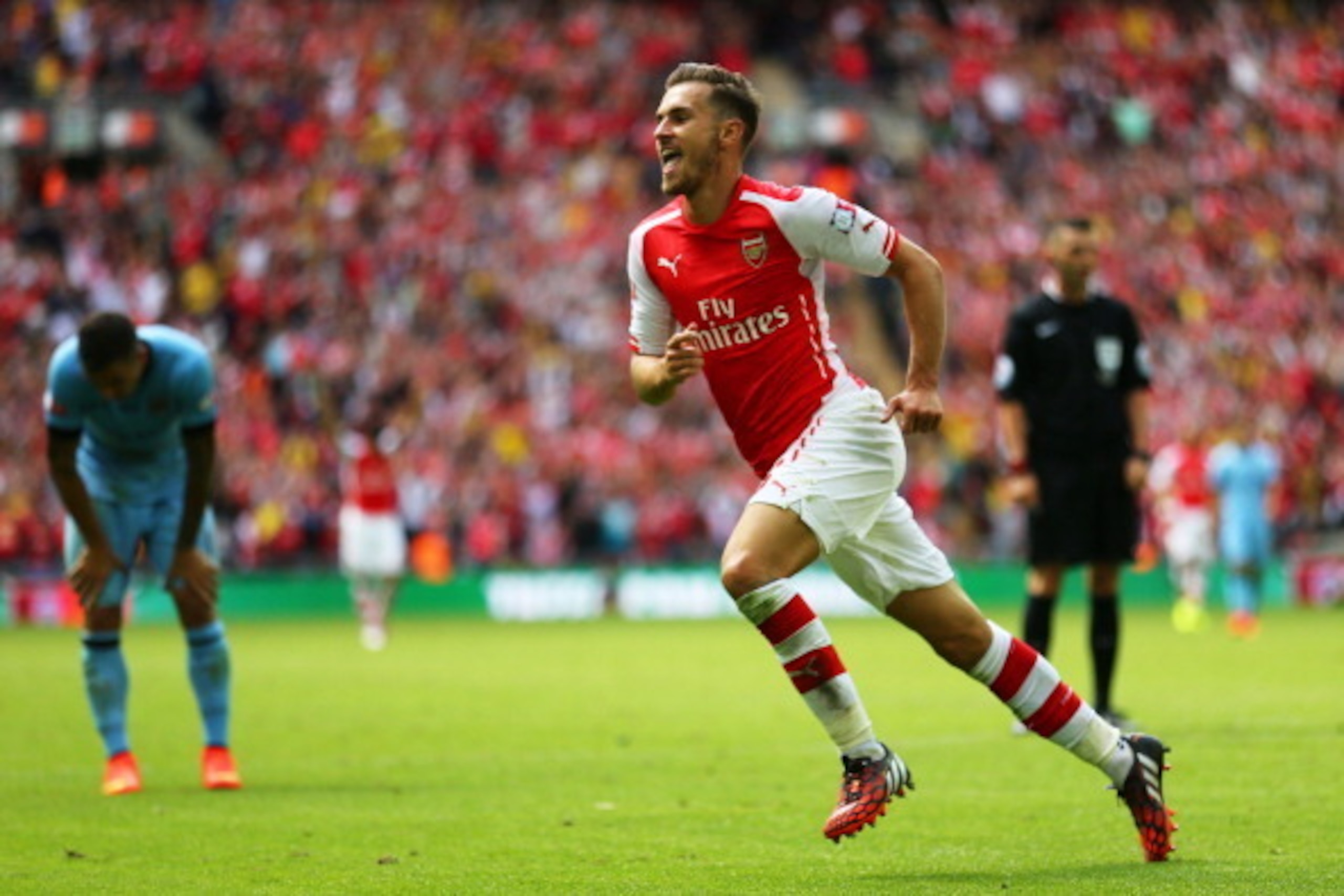 LONDON, ENGLAND - AUGUST 10: Aaron Ramsey of Arsenal celebrates scoring Arsenal's second goal during the FA Community Shield match between Manchester City and Arsenal at Wembley Stadium on August 10, 2014 in London, England. (Photo by Clive Mason/Getty LONDON, ENGLAND - AUGUST 10: Aaron Ramsey of Arsenal celebrates scoring Arsenal's second goal during the FA Community Shield match between Manchester City and Arsenal at Wembley Stadium on August 10, 2014 in London, England. (Photo by Clive Mason/Getty